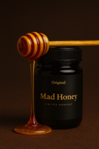 Premium Original Mad Honey jar with honey dipper dripping golden honey, displayed on a black background for an informational article.